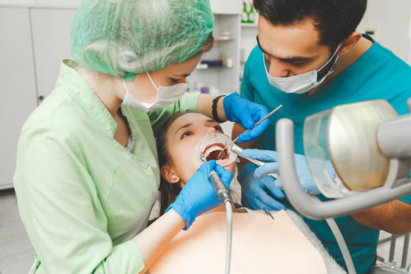 Girl on preventive teeth cleaning at the intern dentist.